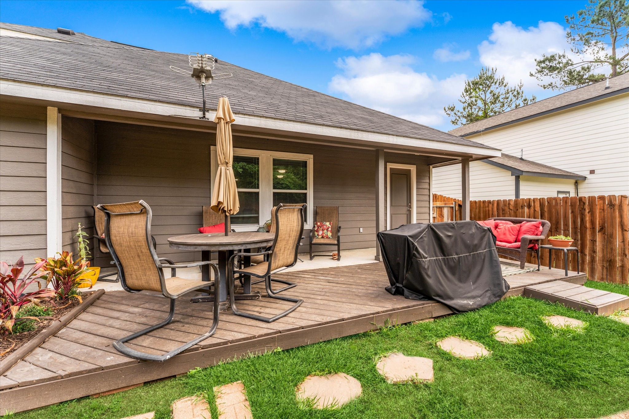3998 Frontier Road Willis, TX 77378 - Photo 29 of 33 a view of a patio with table and chairs potted plants and floor to ceiling window