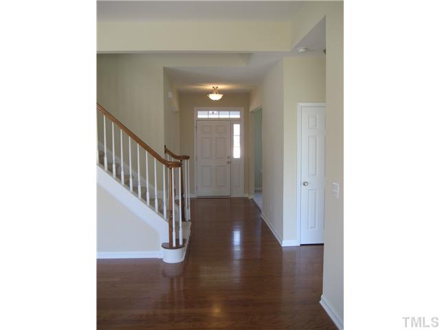 229 Forbes Road, Unit LOT62 Wake Forest, NC 27587 - Photo 5 of 12 Foyer is flanked by the formal living room and dining room and features a double-bullnose with volute handrail at the main stairs. Wood floors greet you on arrival.