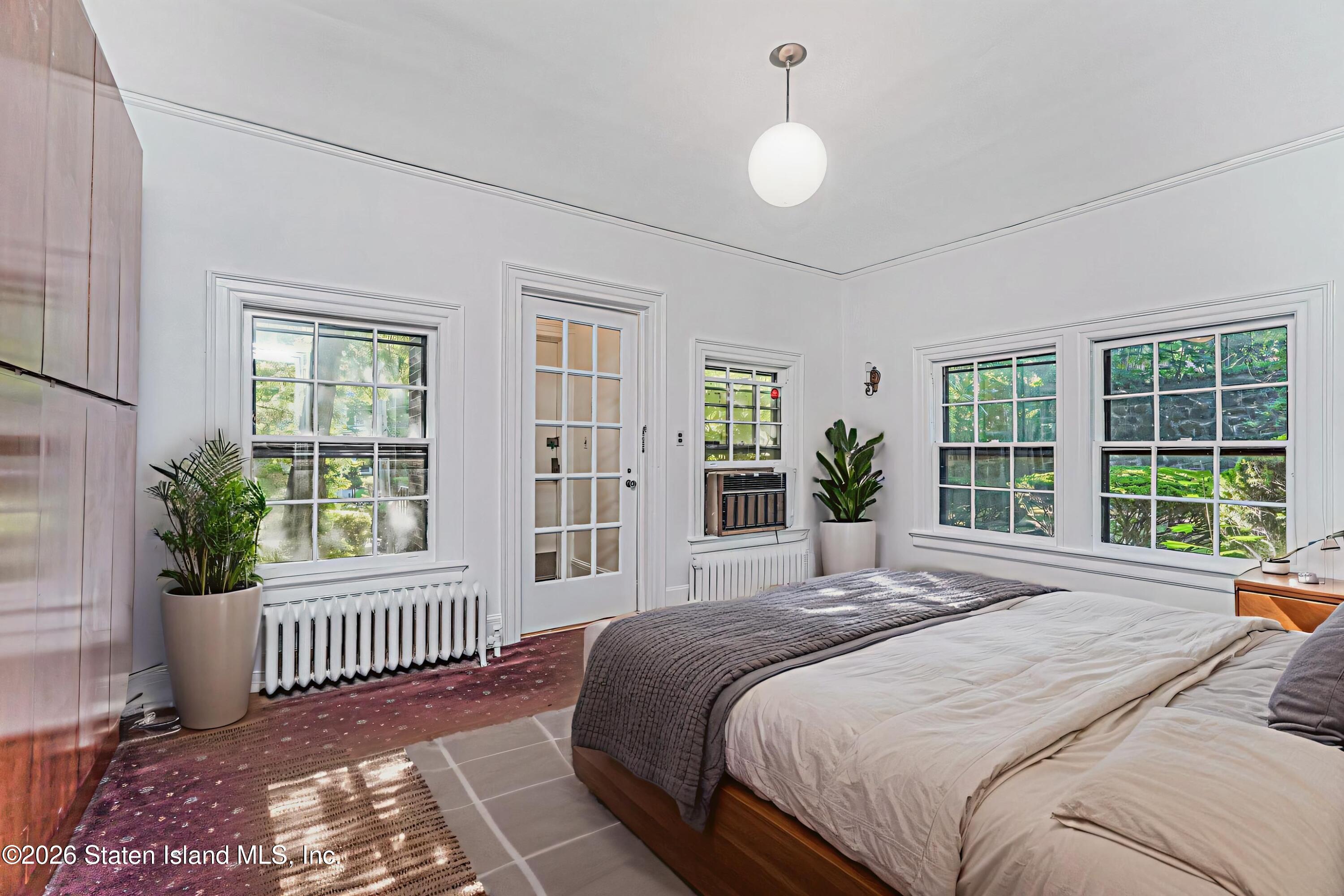 12 Silver Lake Road Staten Island, NY 10301 - Photo 11 of 33 a bedroom with a bed and a large window