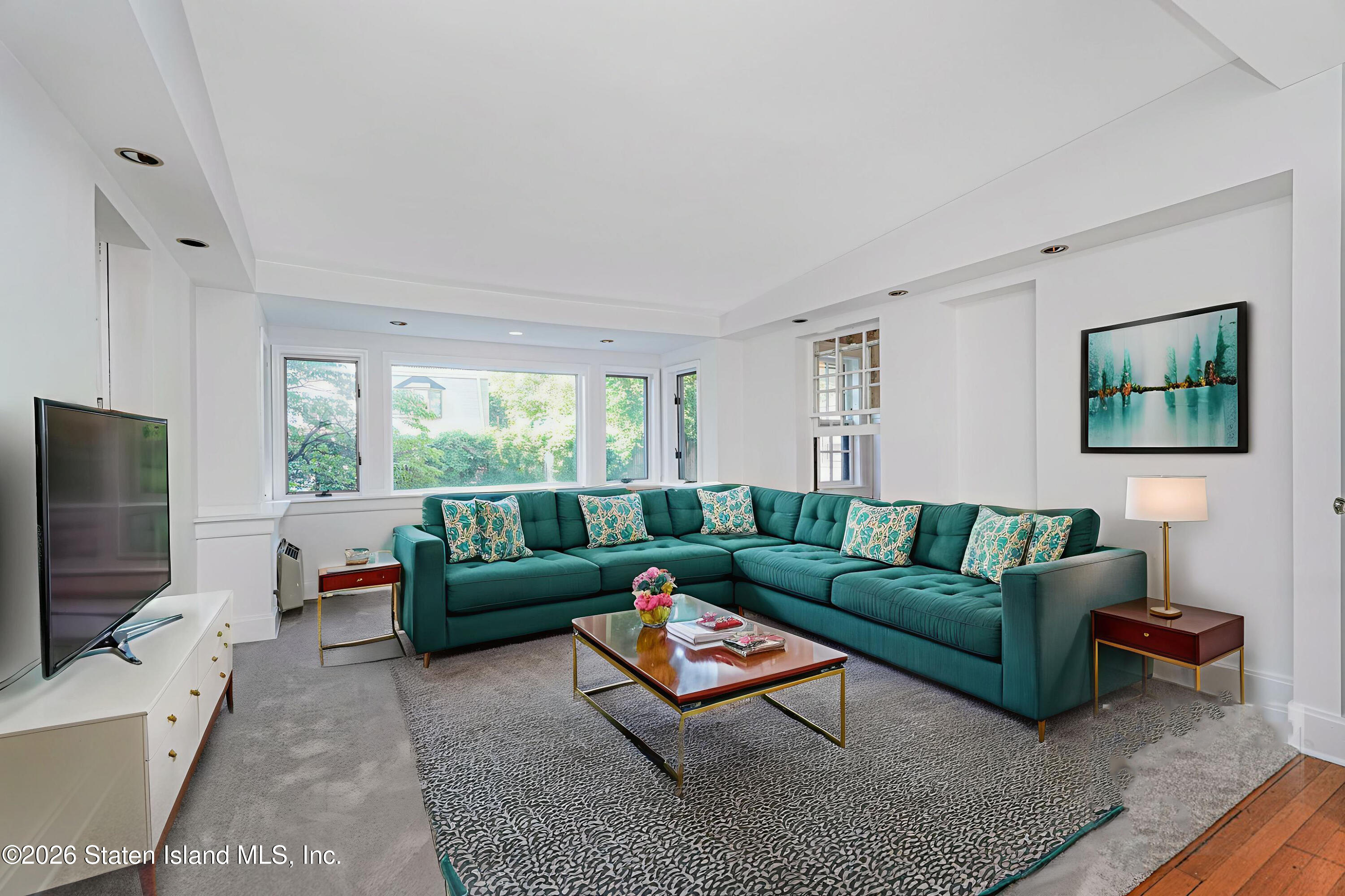 12 Silver Lake Road Staten Island, NY 10301 - Photo 15 of 33 a living room with furniture and a flat screen tv