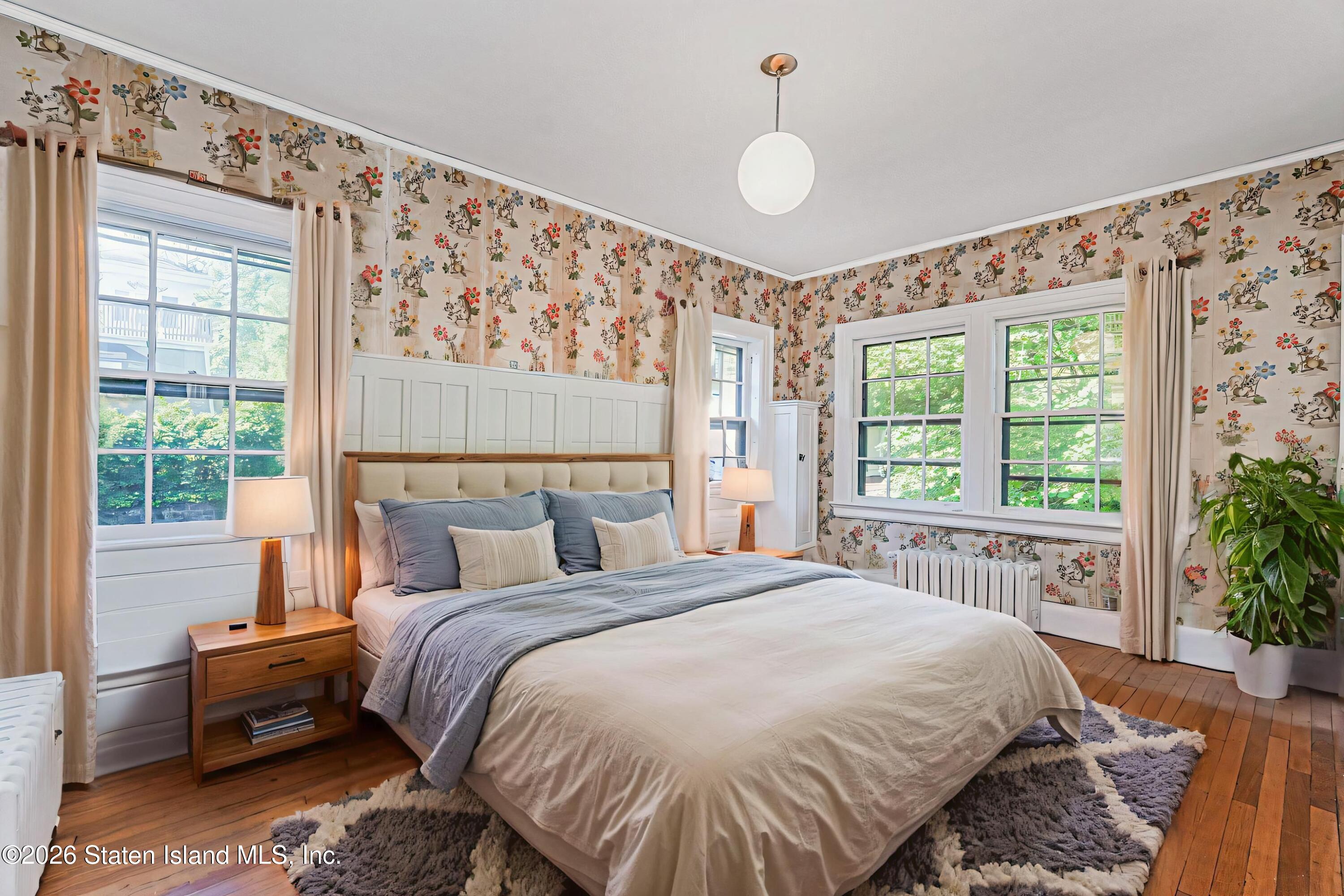 12 Silver Lake Road Staten Island, NY 10301 - Photo 18 of 33 a bed sitting in a bedroom next to a window