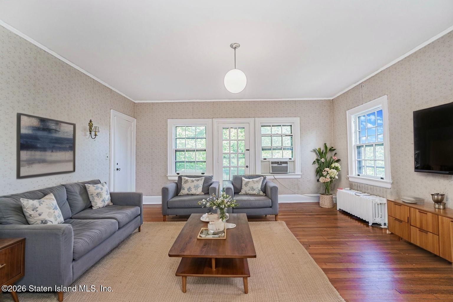 12 Silver Lake Road Staten Island, NY 10301 - Photo 19 of 33 a living room with furniture flat screen tv and wooden floor