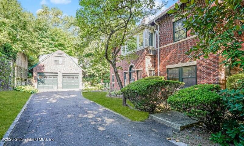 12 Silver Lake Road Staten Island, NY 10301 - Photo 21 of 33 a front view of a house with a garden and trees