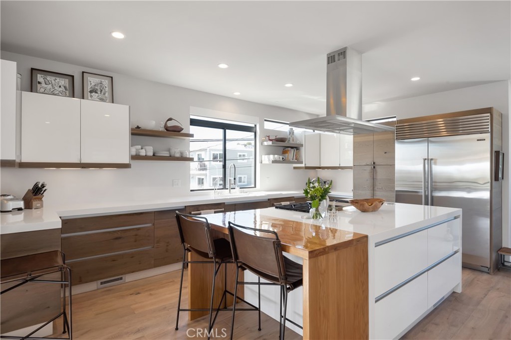 3218 Morningside Drive Hermosa Beach, CA 90254 - Photo 33 of 43 a kitchen with kitchen island a table and chairs in it