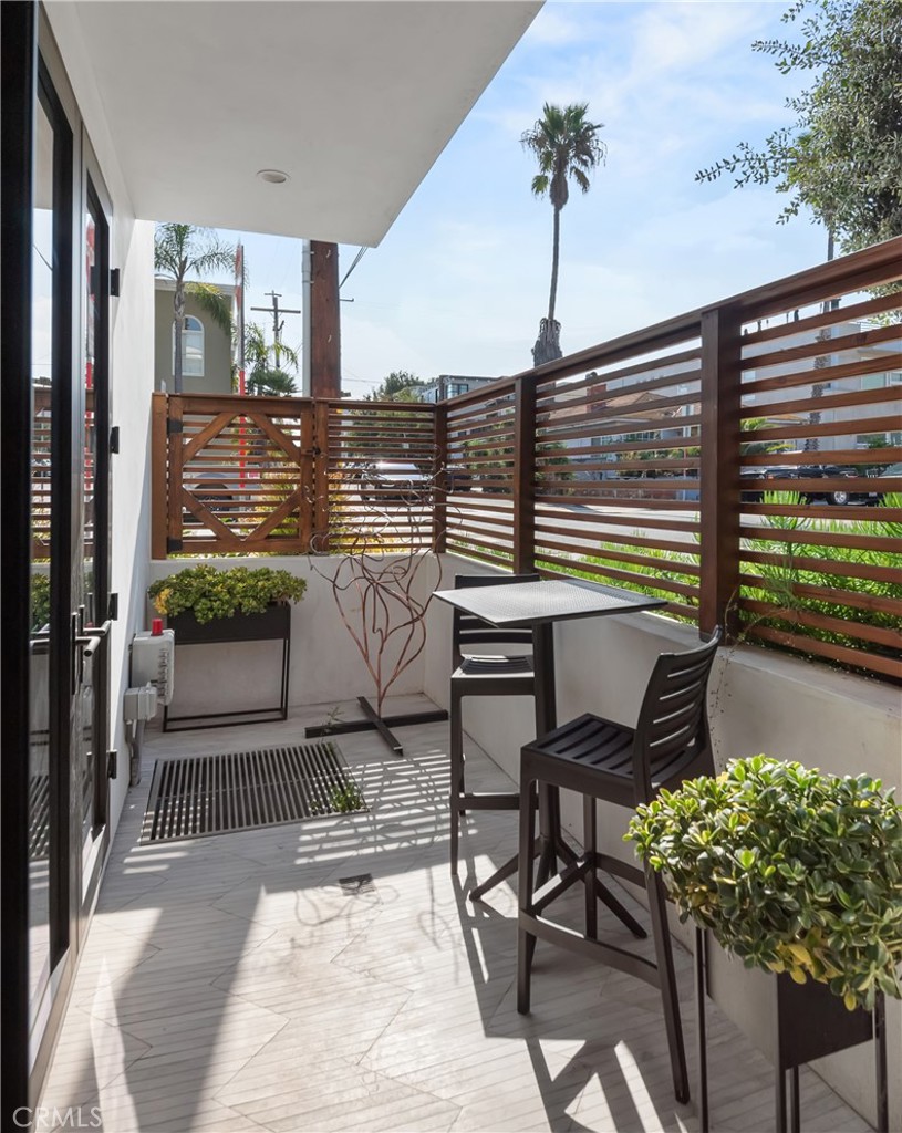 3218 Morningside Drive Hermosa Beach, CA 90254 - Photo 8 of 43 a balcony view with a potted plant on a table and chairs