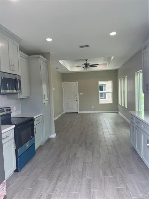 5609 Nightingale Avenue, Unit 2 Mission, TX 78573 - Photo 13 of 13 a view of a kitchen with a sink and dishwasher stove a refrigerator with wooden floor