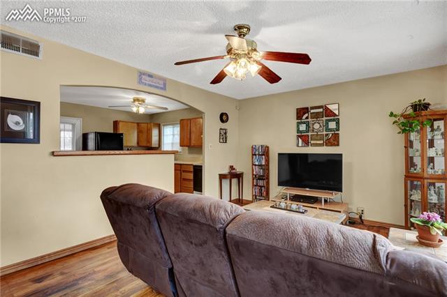1140 Harrison Road Colorado Springs, CO 80905 - Photo 6 of 19 Living room - hardwood floors. Entry to kitchen