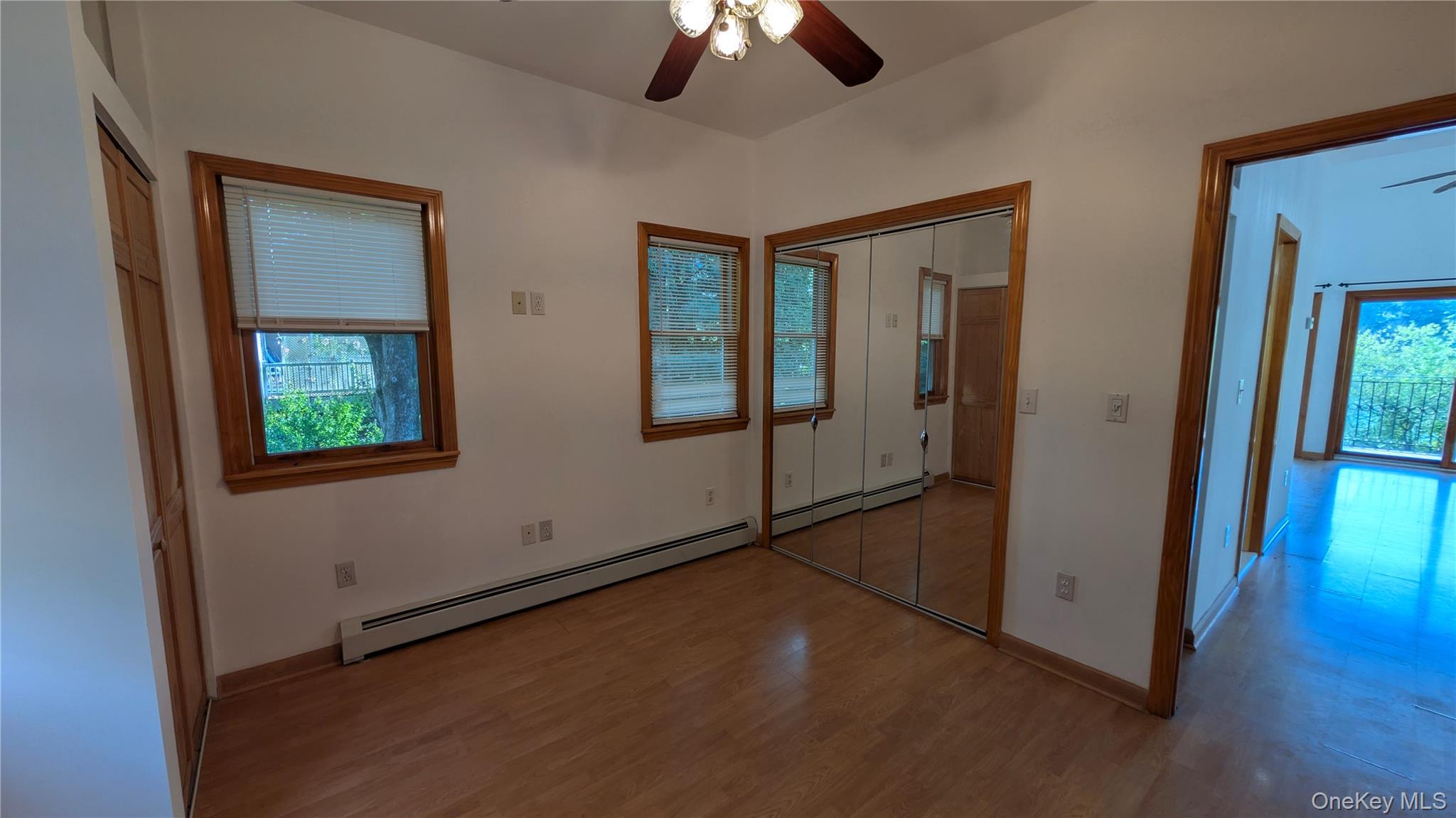 169 Shear Hill Road Mahopac, NY 10541 - Photo 19 of 31 Unfurnished bedroom featuring a closet, wood finished floors, a ceiling fan, and baseboard heating