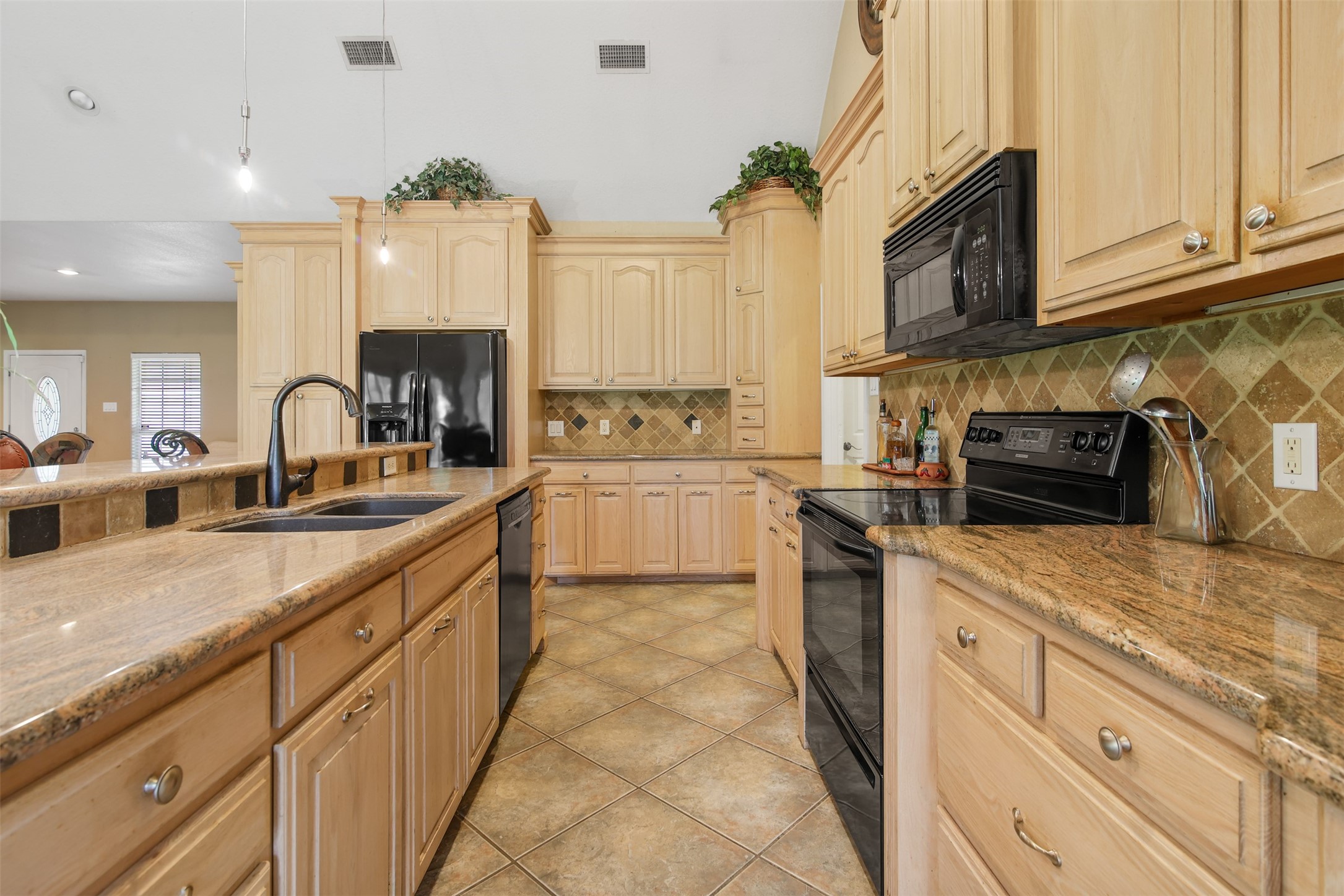 11692 Clark Lane Conroe, TX 77385 - Photo 6 of 35 The kitchen has ample storage for all your needs and plenty of counter space for the chef to prep. The kitchen also features matching black appliances and large double door pantry.