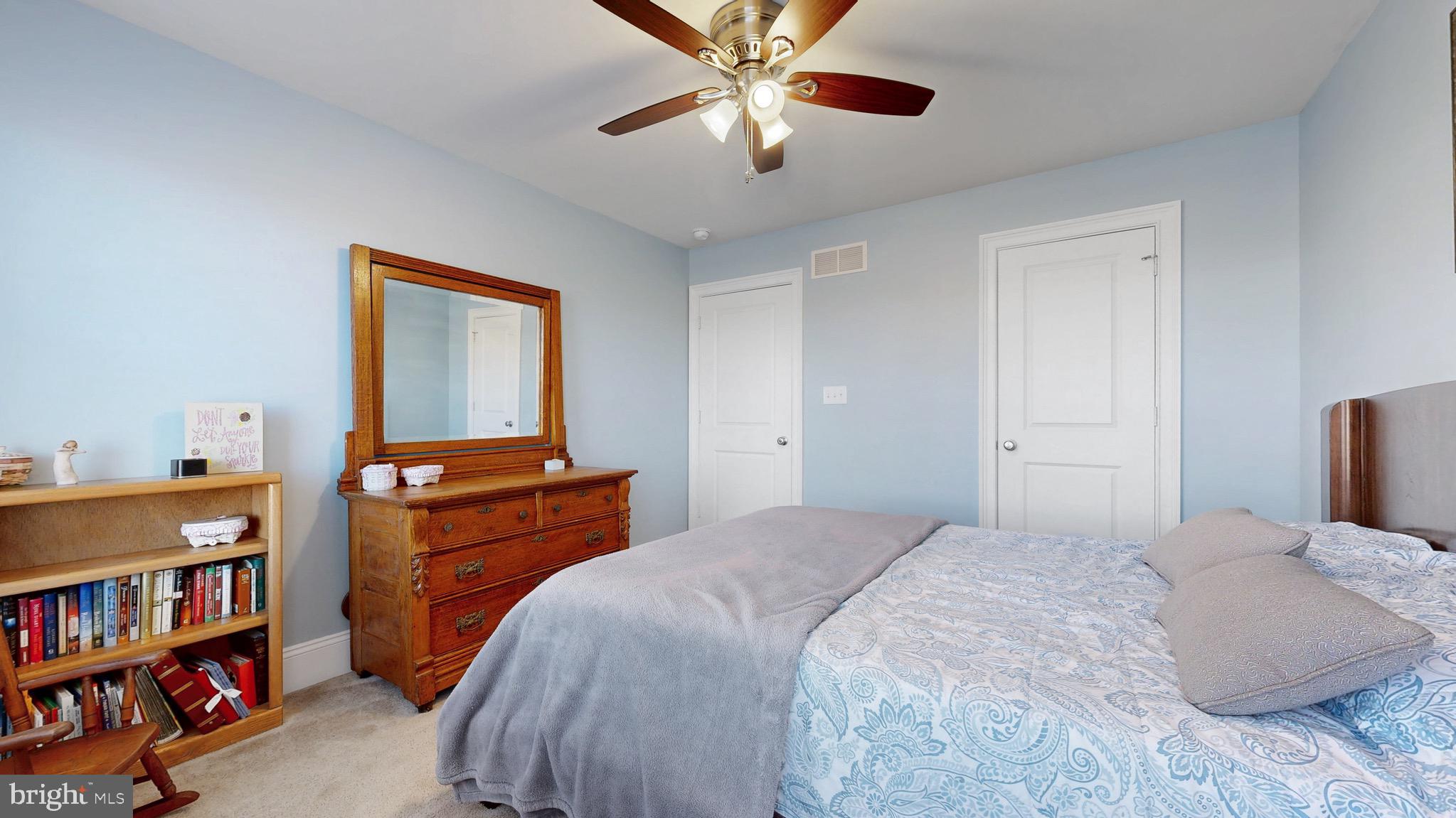819 Mapleton Avenue Middletown, DE 19709 - Photo 30 of 56 a bedroom with a bed and a book shelf