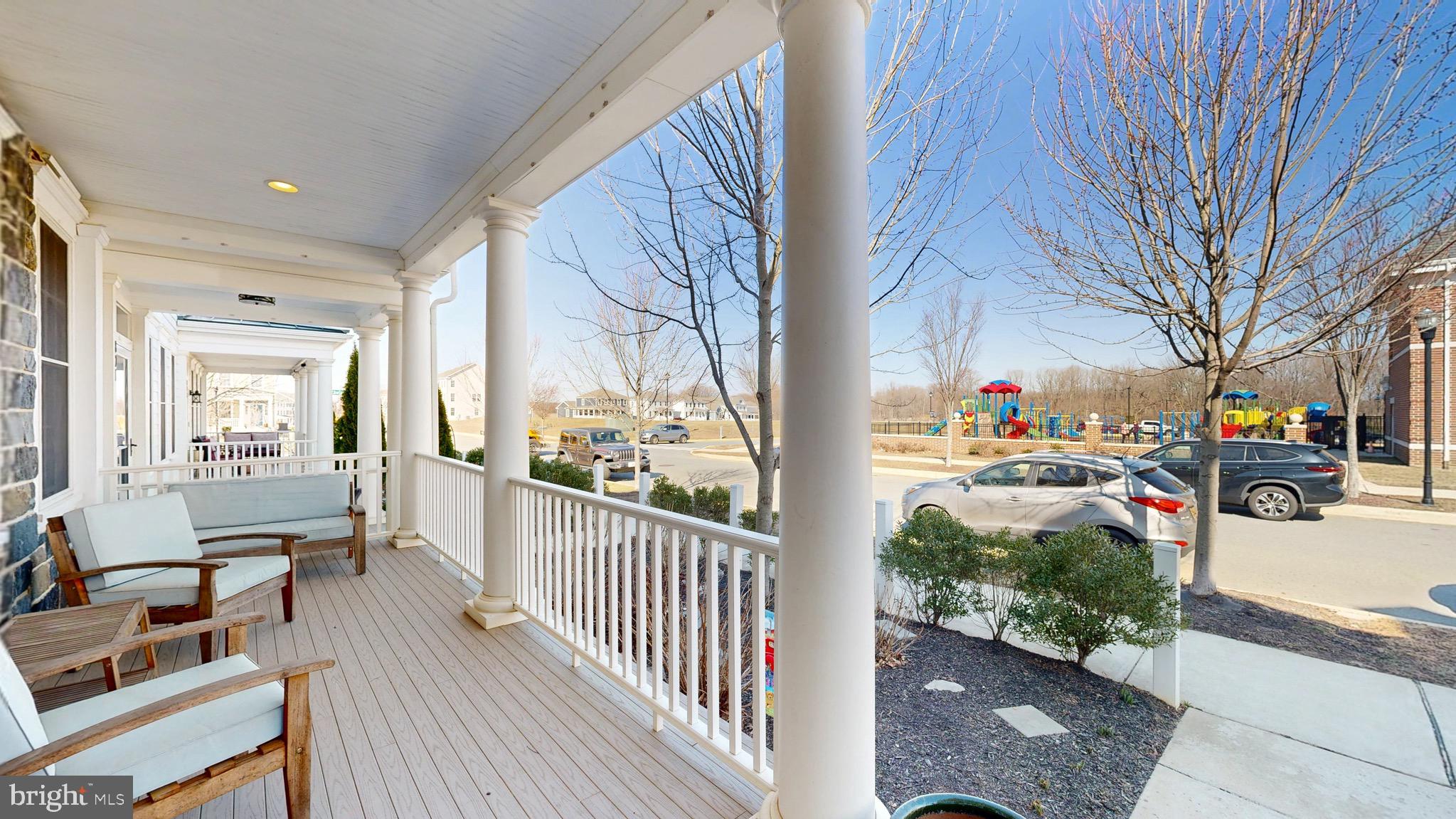 819 Mapleton Avenue Middletown, DE 19709 - Photo 5 of 56 a view of a porch with wooden floor and iron fence