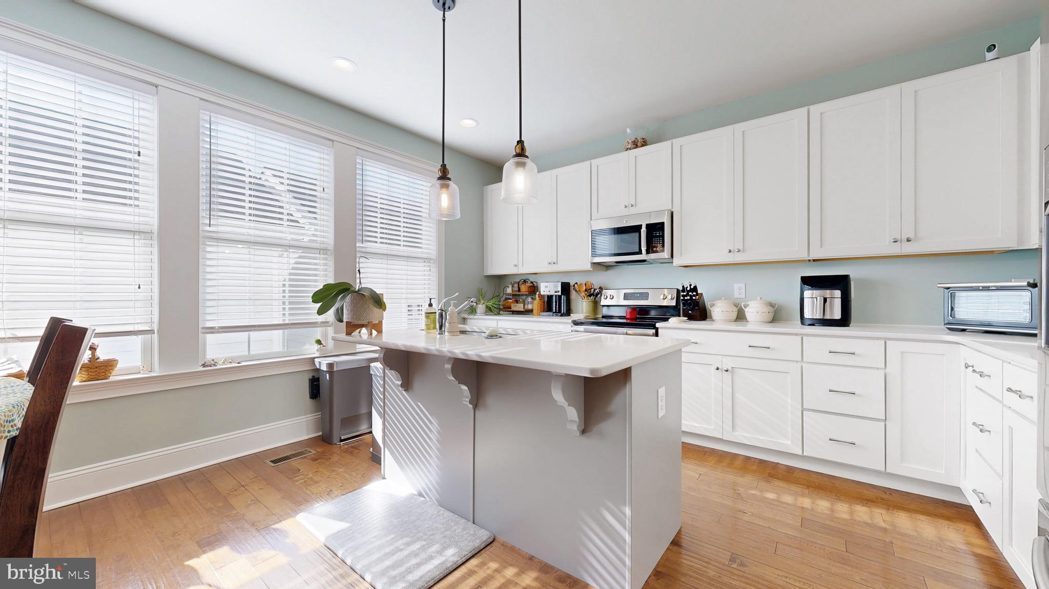 819 Mapleton Avenue Middletown, DE 19709 - Photo 7 of 56 a kitchen with kitchen island granite countertop a sink cabinets and window