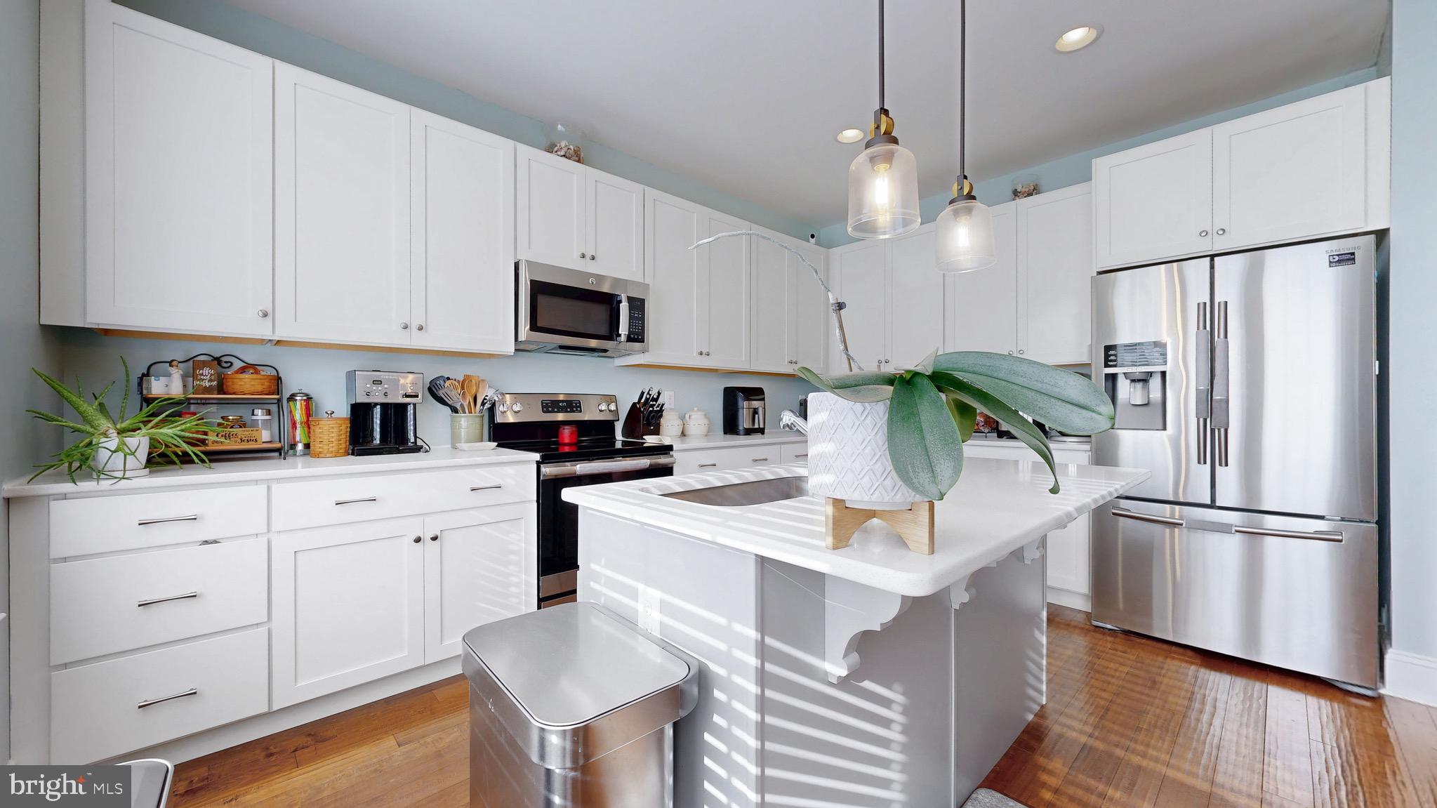 819 Mapleton Avenue Middletown, DE 19709 - Photo 8 of 56 a kitchen with stainless steel appliances granite countertop a refrigerator a stove a sink dishwasher and white cabinets with wooden floor