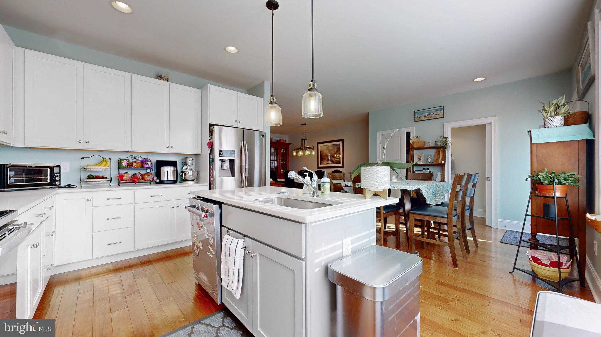 819 Mapleton Avenue Middletown, DE 19709 - Photo 10 of 56 a kitchen with stainless steel appliances kitchen island granite countertop a table chairs and a refrigerator