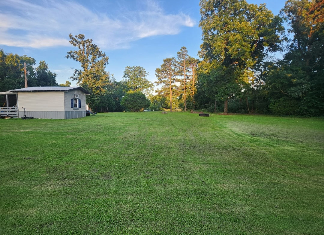 57443 667th Colcord, OK 74338 - Photo 7 of 51 Expansive green lawn with mature trees bordering the property