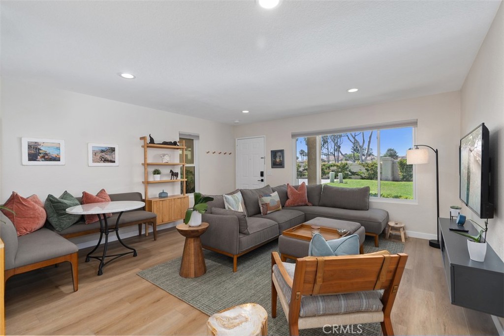 13 Pearl Laguna Niguel, CA 92677 - Photo 2 of 25 a living room with furniture a flat screen tv and a refrigerator