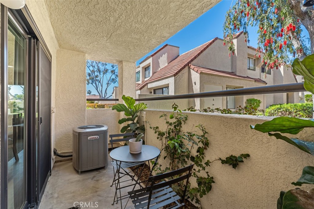13 Pearl Laguna Niguel, CA 92677 - Photo 21 of 25 a balcony with table and chairs