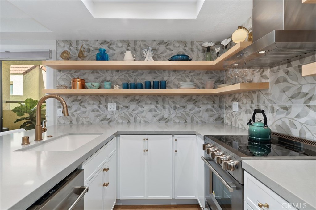 13 Pearl Laguna Niguel, CA 92677 - Photo 9 of 25 a kitchen with a sink a stove and cabinets