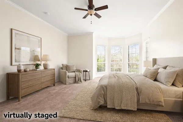 a spacious bedroom with a bed a large mirror and a large window