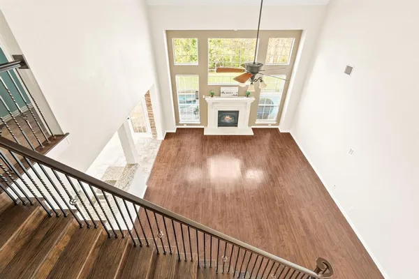 en empty room with a ceiling fan and carpet