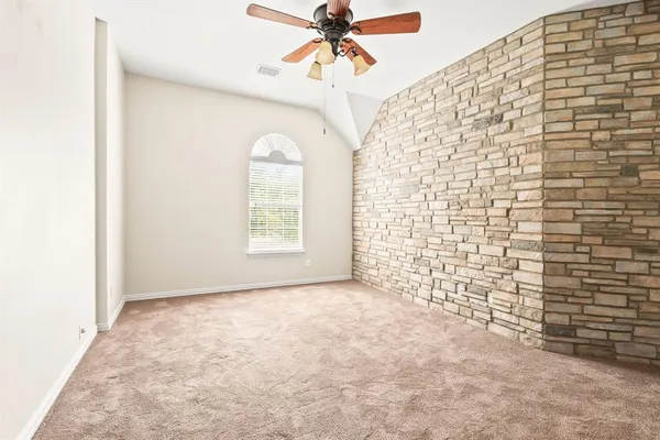 a view of a livingroom with a ceiling fan and window