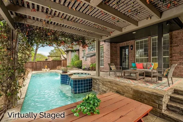 a backyard of a house with table and chairs