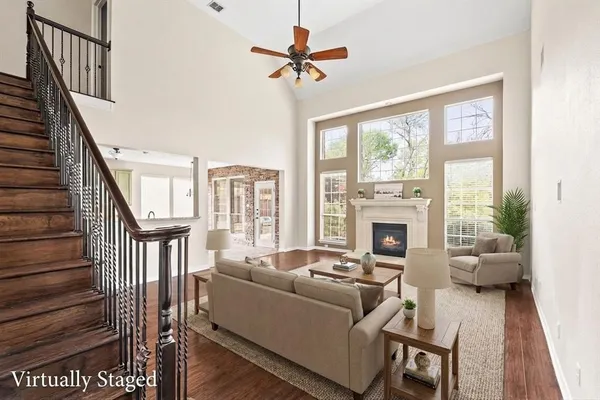 a living room with furniture fireplace and a large window