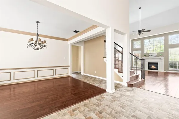 a view of a livingroom with wooden floor and a ceiling fan