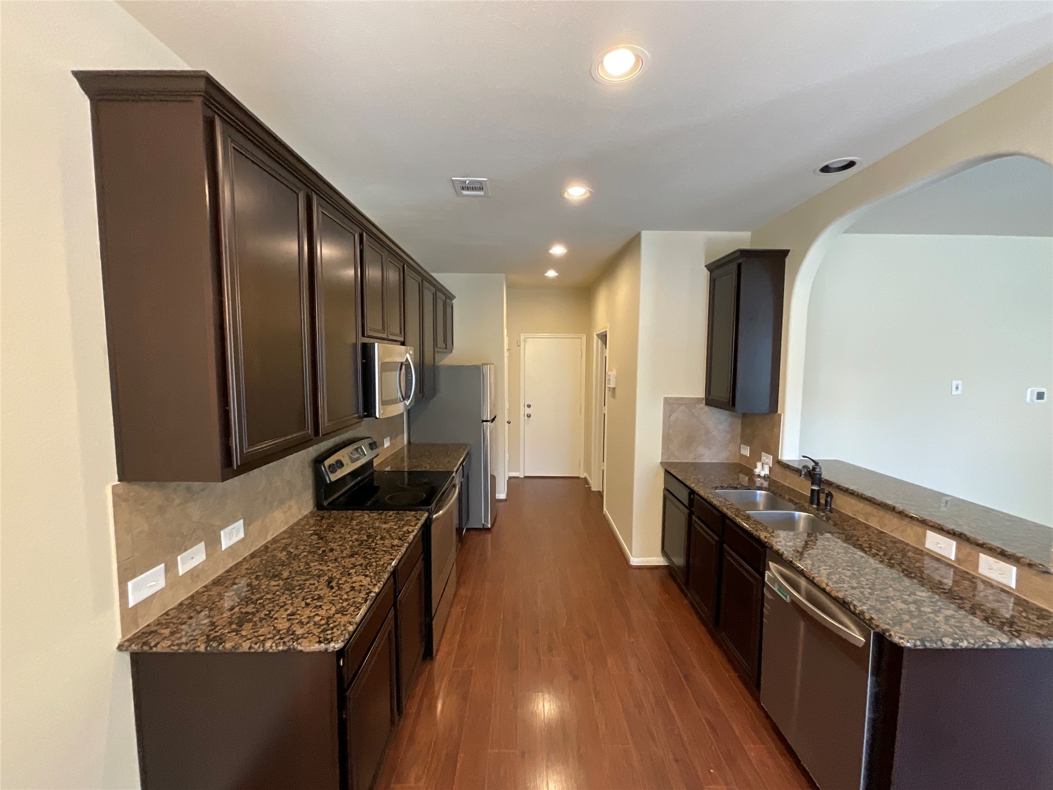 1911 Conn Creek Road Cedar Park, TX 78613 - Photo 16 of 39 a kitchen with granite countertop stainless steel appliances and wooden cabinets