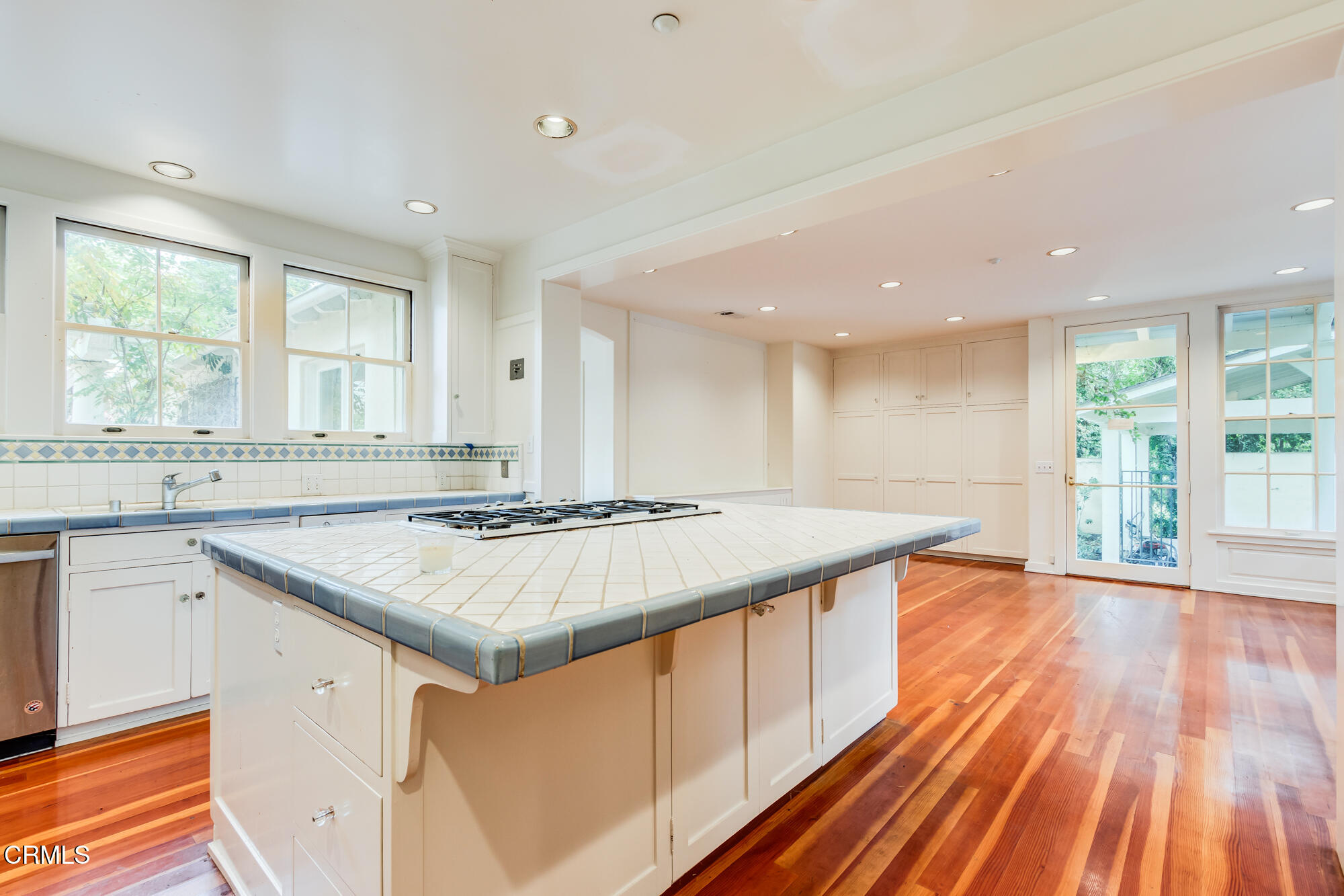 2050 Ashbourne Drive South Pasadena, CA 91030 - Photo 4 of 26 a kitchen with a stove a sink wooden floor and a window