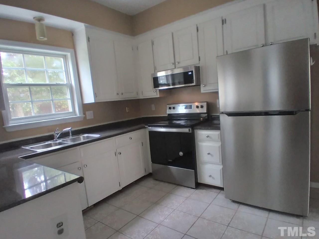 6820 Coventry Ridge Road Raleigh, NC 27616 - Photo 3 of 12 a kitchen with stainless steel appliances a refrigerator sink and microwave