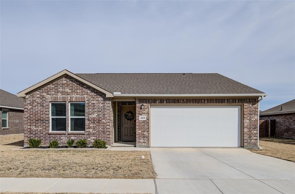 905 Avagail Avenue Springtown, TX 76082 - Photo 1 of 26 Ranch-style home with roof with shingles, brick siding, driveway, and a garage