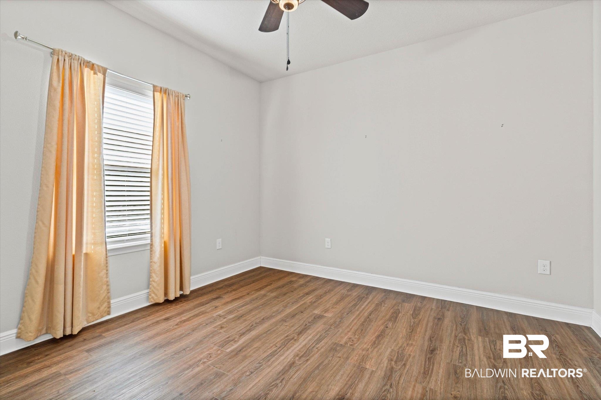 10207 Dunleith Loop Daphne, AL 36526 - Photo 11 of 23 Spare room with wood finished floors and a ceiling fan