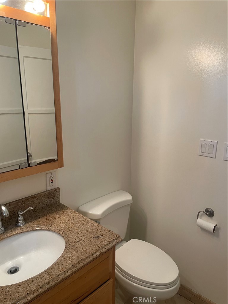 5901 Woodman Valley, Unit 5901 Valley Glen, CA 91401 - Photo 4 of 8 a bathroom with a granite countertop sink and a mirror