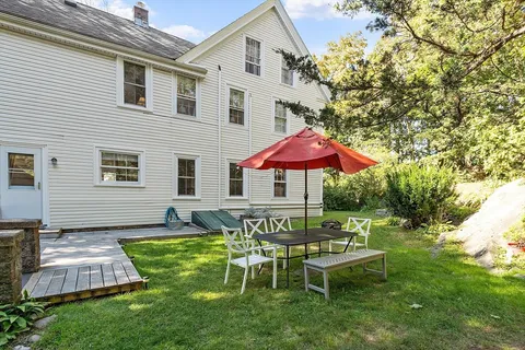 a view of a house with a backyard