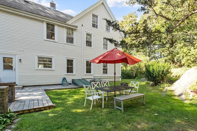 a view of a house with a backyard
