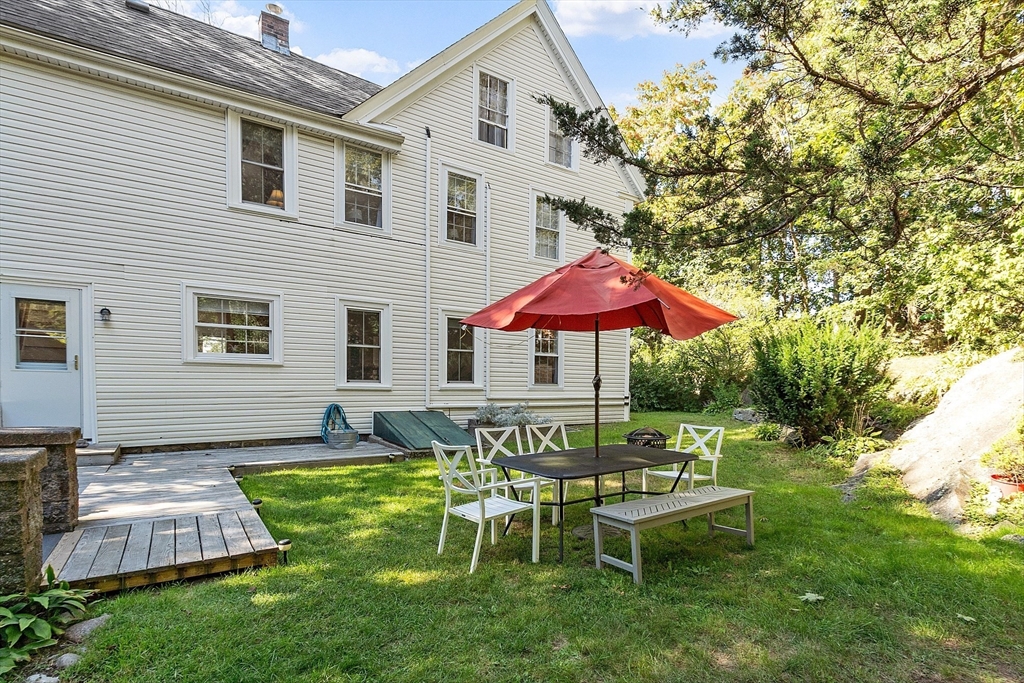 a view of a house with a backyard