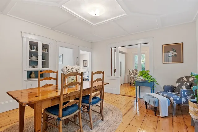 a view of a dining room with furniture and chandelier