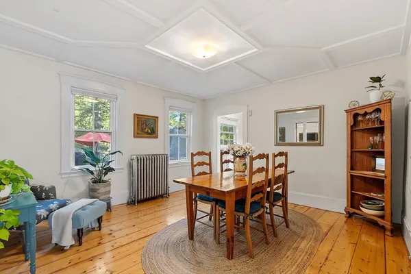 a dining room with furniture and wooden floor