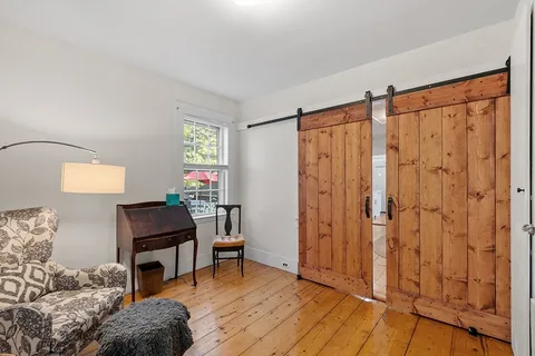 a workspace room with furniture and wooden floor