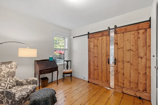 a workspace room with furniture and wooden floor
