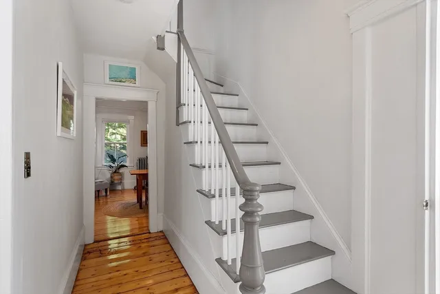 a view of entryway and hall with wooden floor
