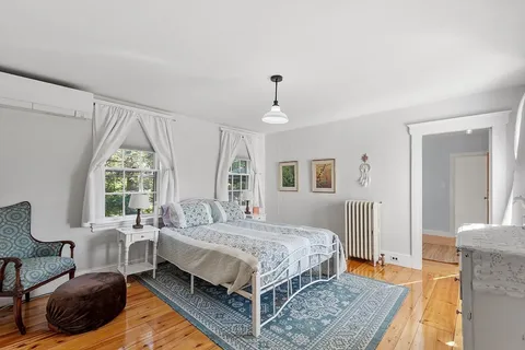 a bedroom with a bed window and a couch