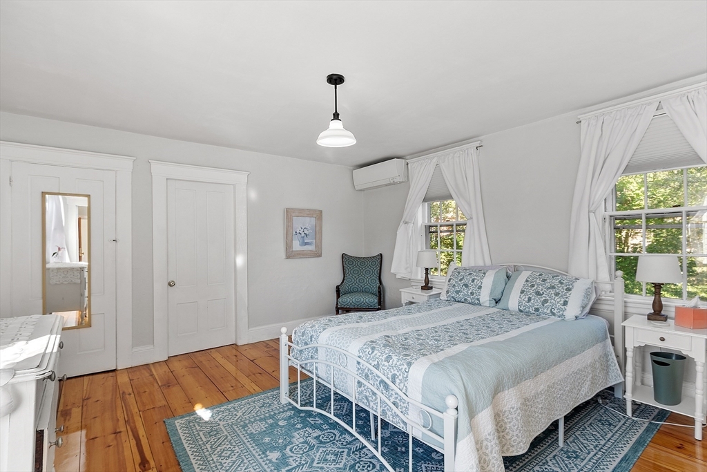 1101 Washington Street, Unit WINTER Gloucester, MA 01930 - Photo 36 of 41 a bedroom with a bed and wooden floor