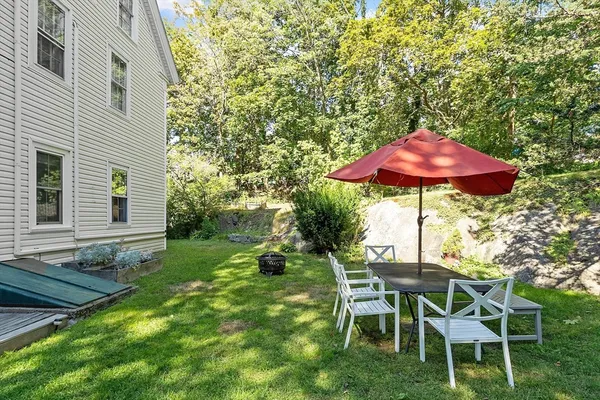 a patio with a yard table and chairs