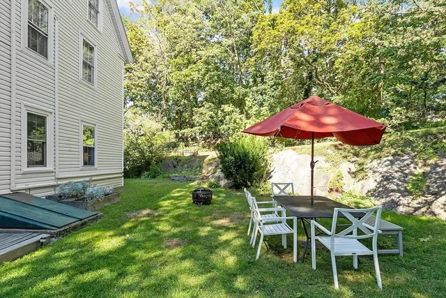 a patio with a yard table and chairs