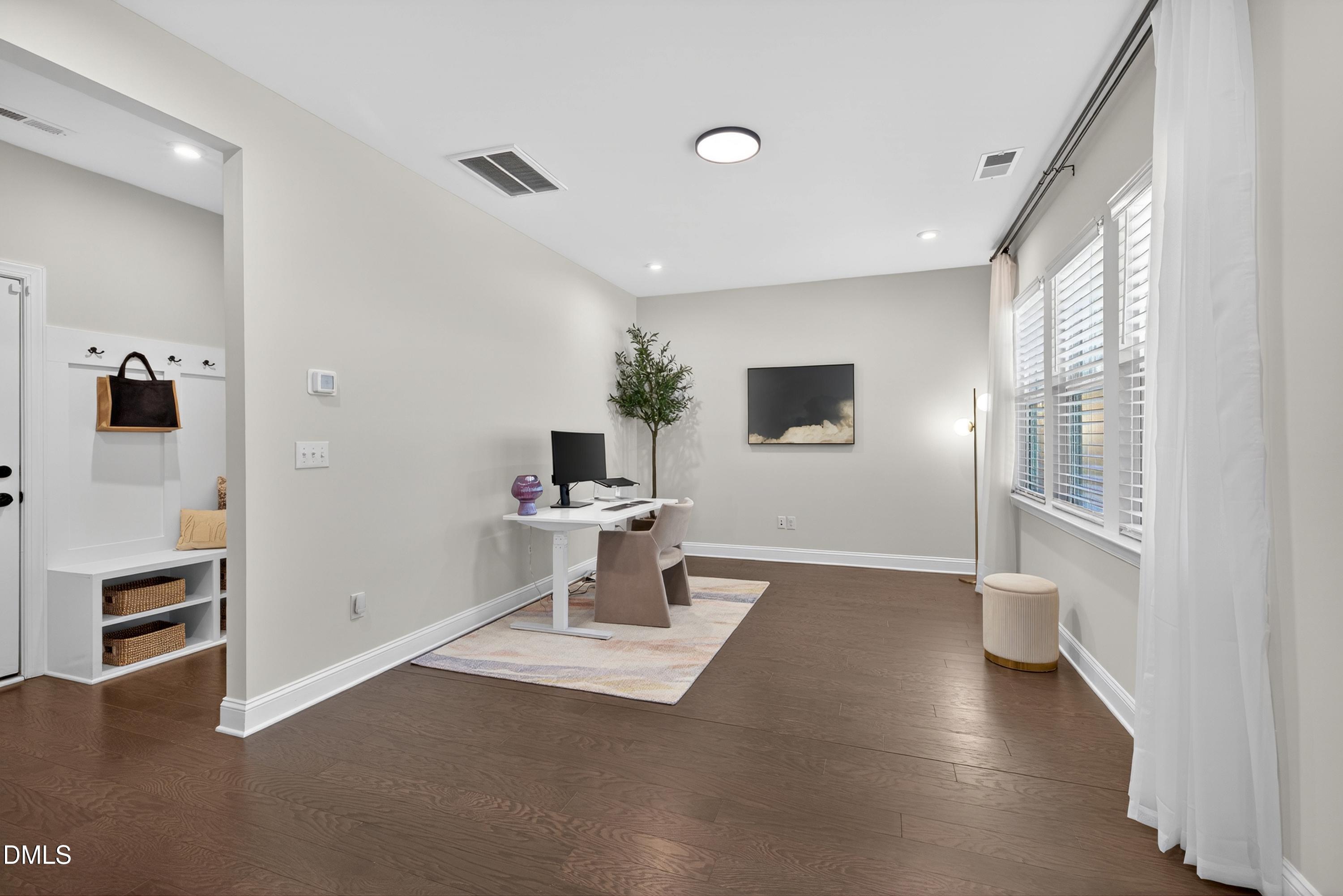 1063 Danvers Loop Apex, NC 27523 - Photo 54 of 67 a living room with a window furniture and a wooden floor