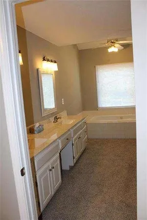 a bathroom with a double vanity sink and a mirror