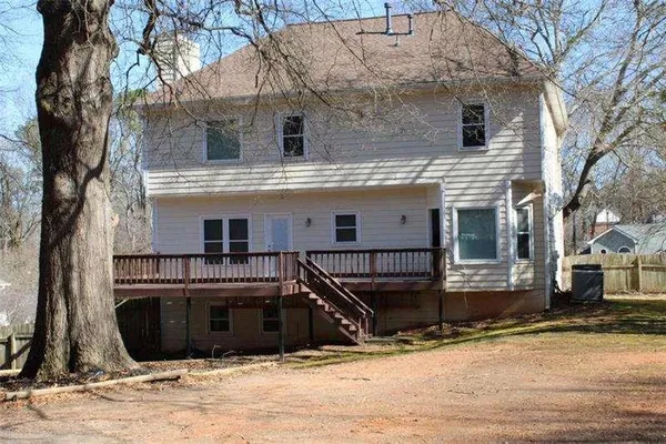 a view of a house with a large tree