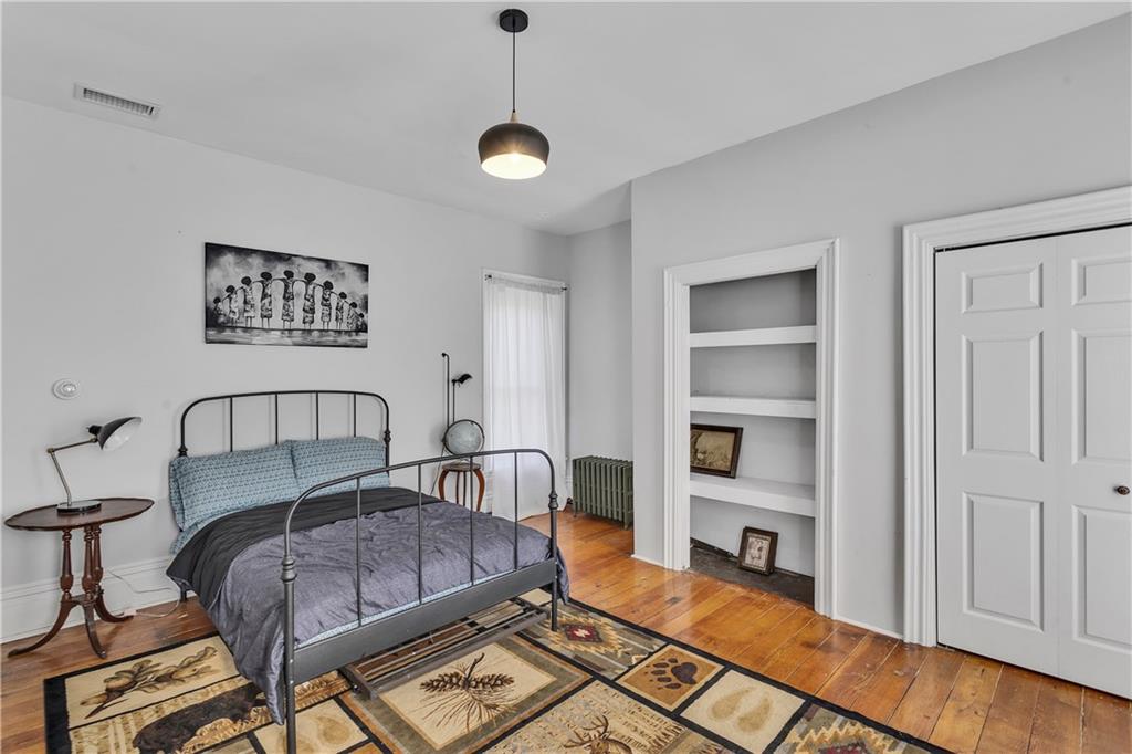 389 East Rices Landing Road East Millsboro, PA 15433 - Photo 28 of 42 Second bedroom with warm, wooden floors, built in bookcase and roomy closet.